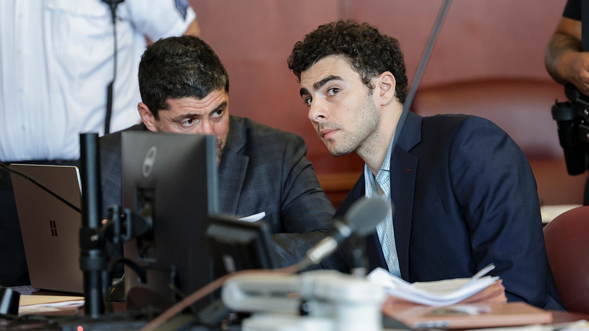 Luigi Mangione appearing at an evidence suppression hearing in a courtroom.