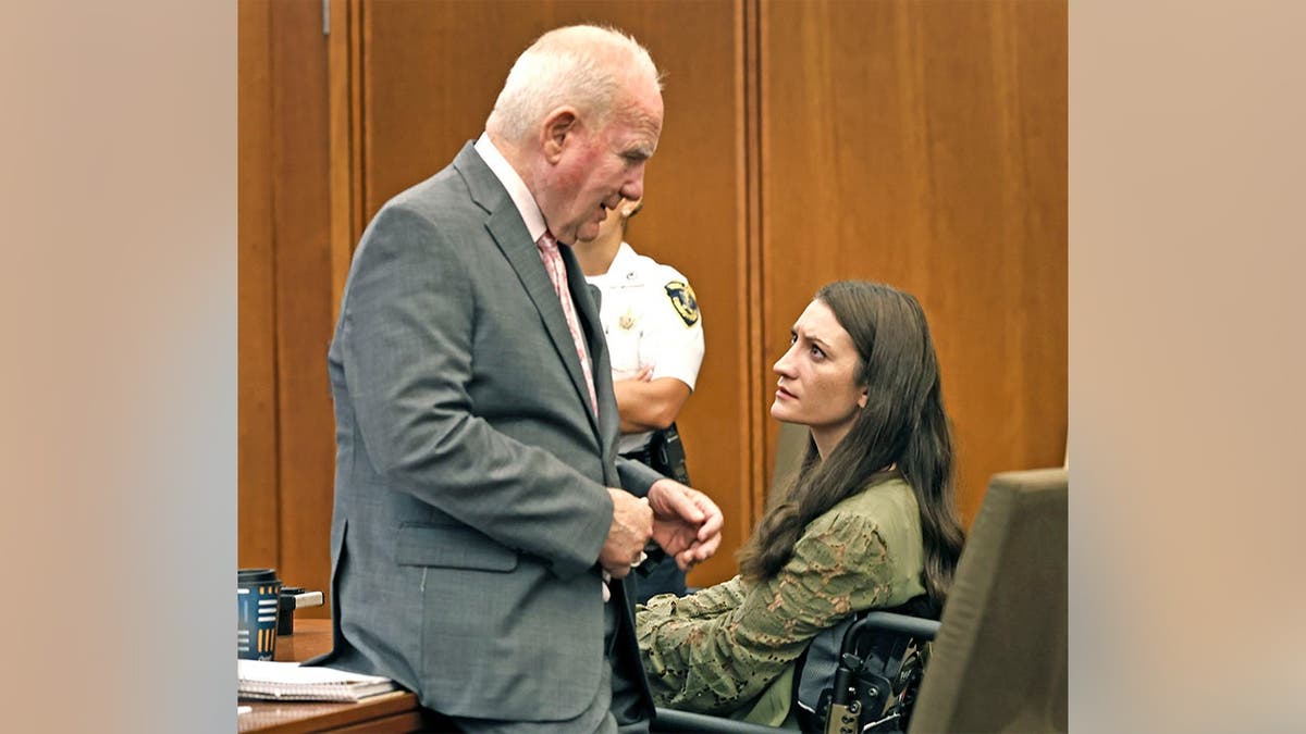 Lindsay Clancy confers with her lawyer, Kevin Reddington