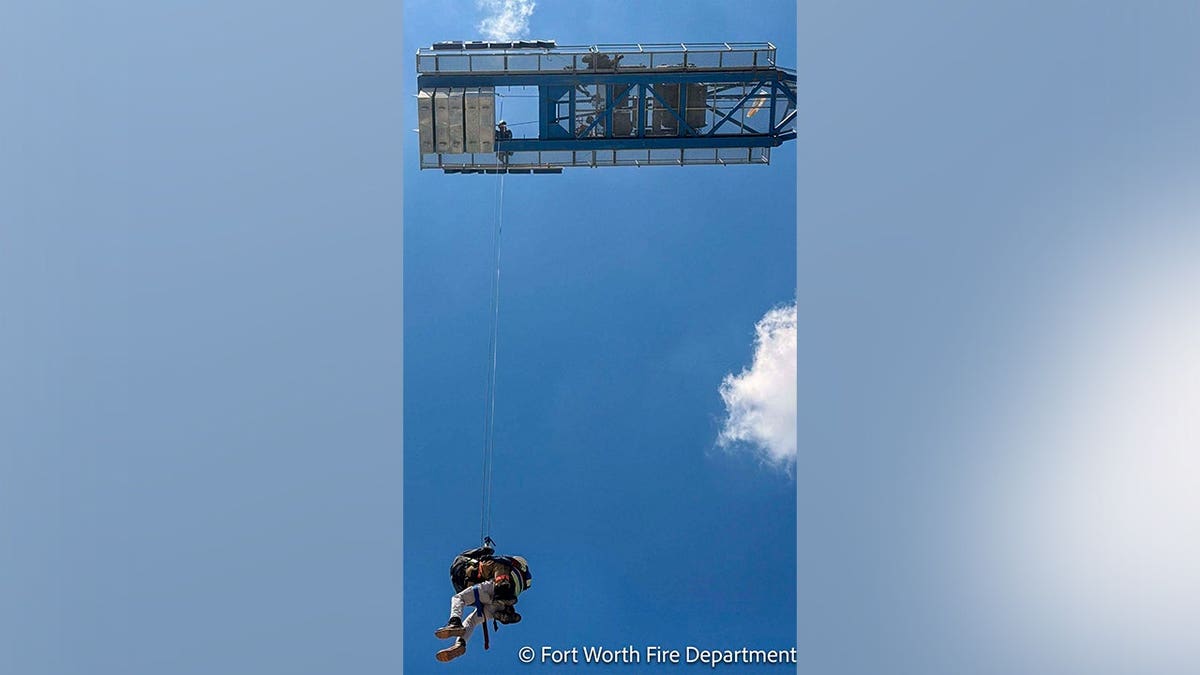 The Fort Worth Fire Department shared photos in a Facebook post that described a rescue operation to lower an individual from a towering crane.