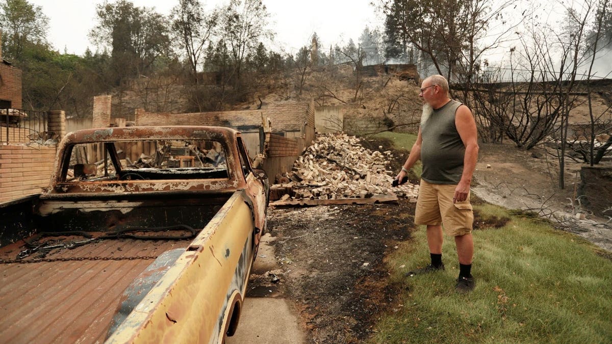 Allen Sather in front of the Chevrolet truck he lost in a fire in Spokane, Washington
