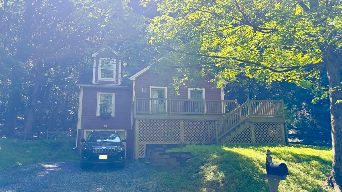 image shows red house