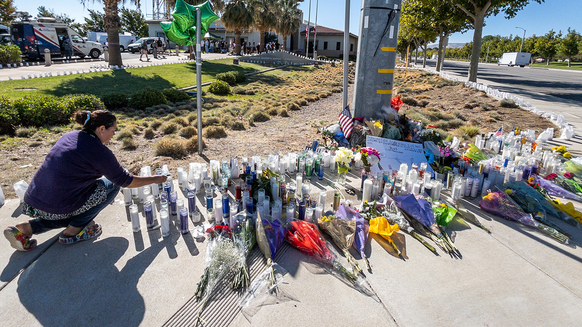 A sidewalk memorial grows at the corner of Sierra Highway and Avenue Q for slain LA Deputy Ryan Clinkunbroomer