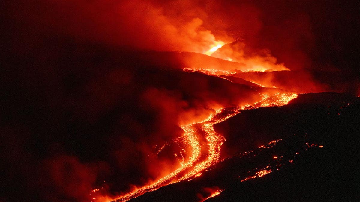 Mount Etna emits lava flows down the volcano slopes near Catania, Italy.