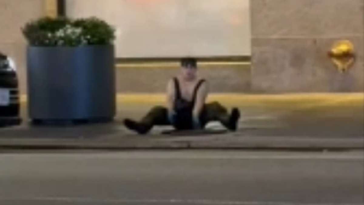 Another individual seen exiting the manhole