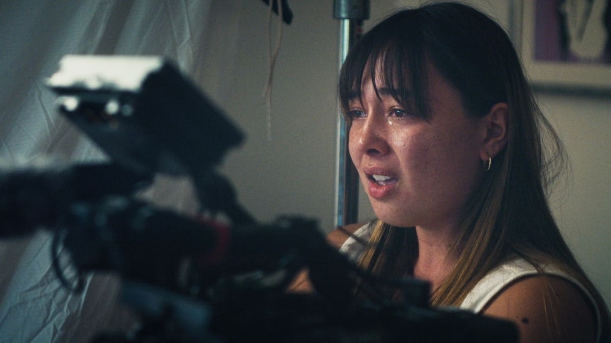 Sophia Maddox cries while looking downward.