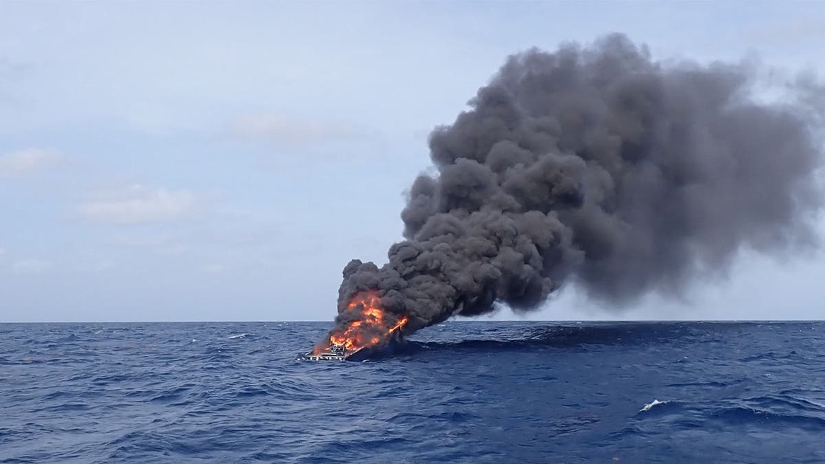 image shows boat on fire in water