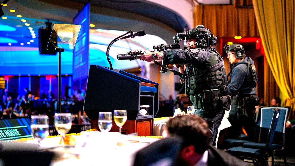 Armed Secret Service agents stand on stage during a shooting incident at the Washington Hilton.