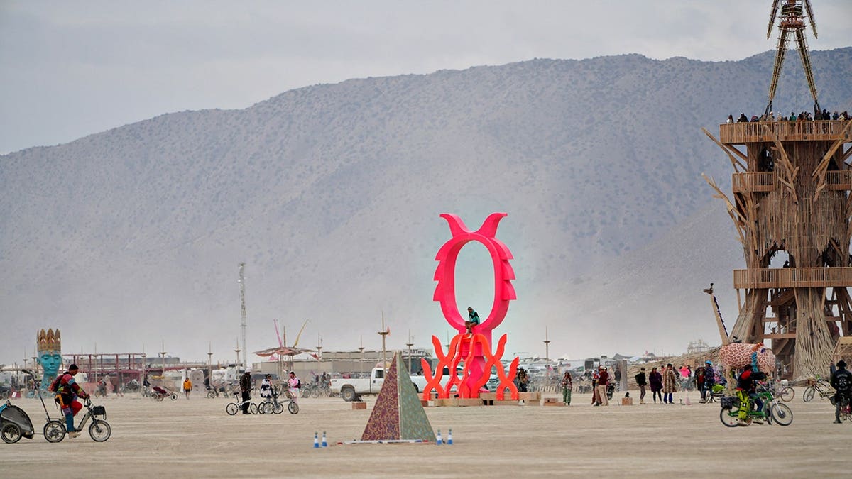 Burning Man attendees sample art during a dust storm at Black Rock City.