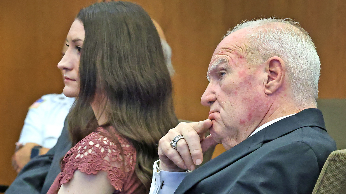 Lindsay clancy in a maroon top sitting next to her lawyer Kevin Reddington, in a dark suit with light shirt, in court