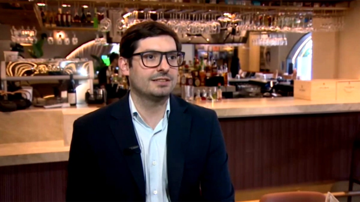 Stefano Cremasco-Cicero sits for a TV interview in his restaurant