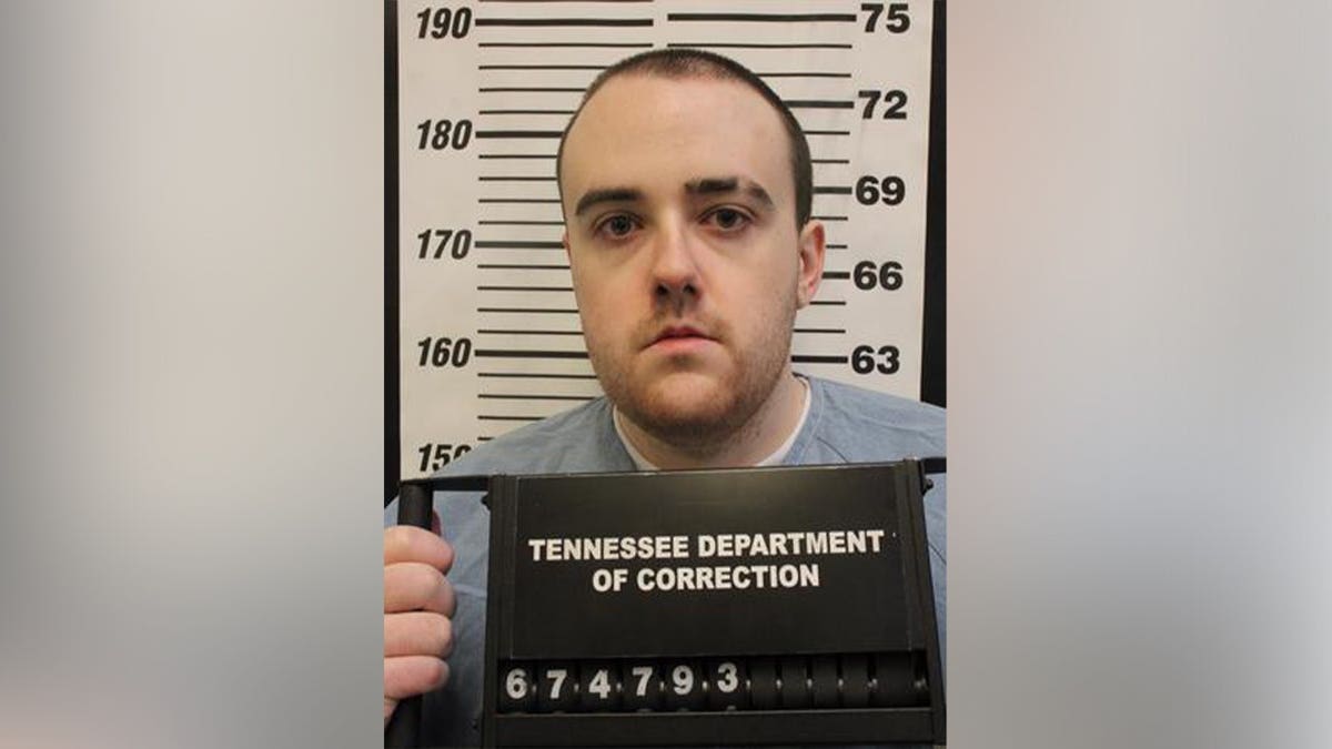 Tennessee Department of Correction mugshot of Jacob Allen Morley wearing a gray prison shirt and holding an inmate identification board.