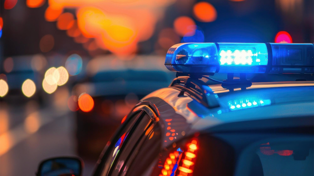 Denver Police Department patrol car with emergency lights flashing