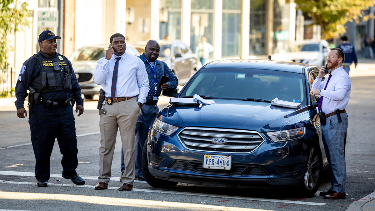 Law enforcement officials stand near The Obenshain Center after a woman was shot in front of the building, Thursday, Oct. 29, 2026, in Richmond, Va.