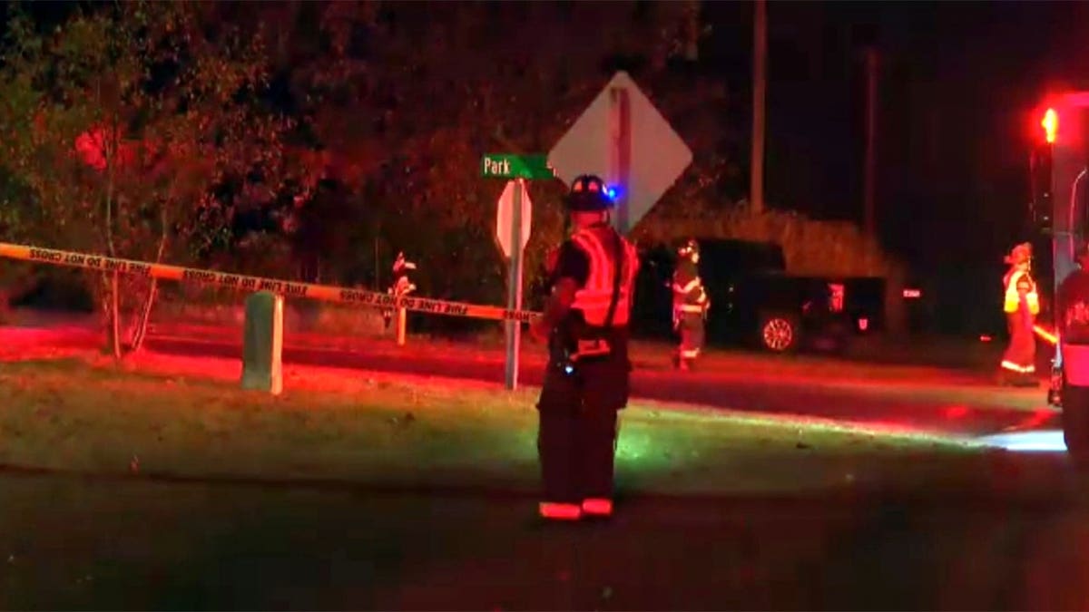 First responders stand at a small plane crash scene in Dellona, Wisconsin.