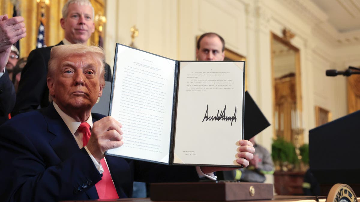 WASHINGTON, DC - APRIL 08: U.S. President Donald Trump holds up an executive order on American energy production after signing it during a ceremony in the East Room of the White House on April 08, 2025 in Washington, DC. The Trump administration has elected to roll back Biden-era environmental policies with the intention to help revive coal-fired plants in order to restore America’s energy independence.