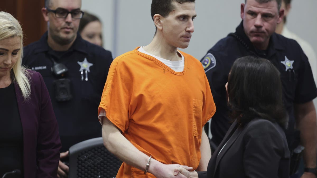 Handcuffed Kohberger shakes hands with defense attorney Elisa Massoth after his sentencing