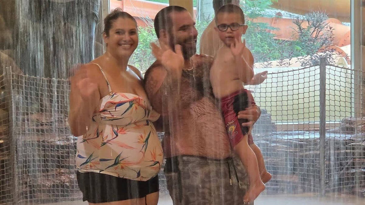image shows family in pool