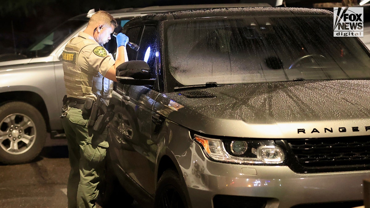 FBI agents inspect a Range Rover following a traffic stop related to Nancy Guthrie's disappearance
