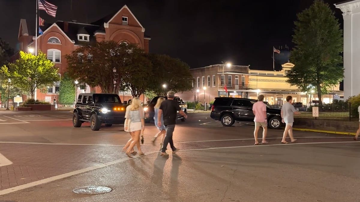image shows people walking outside