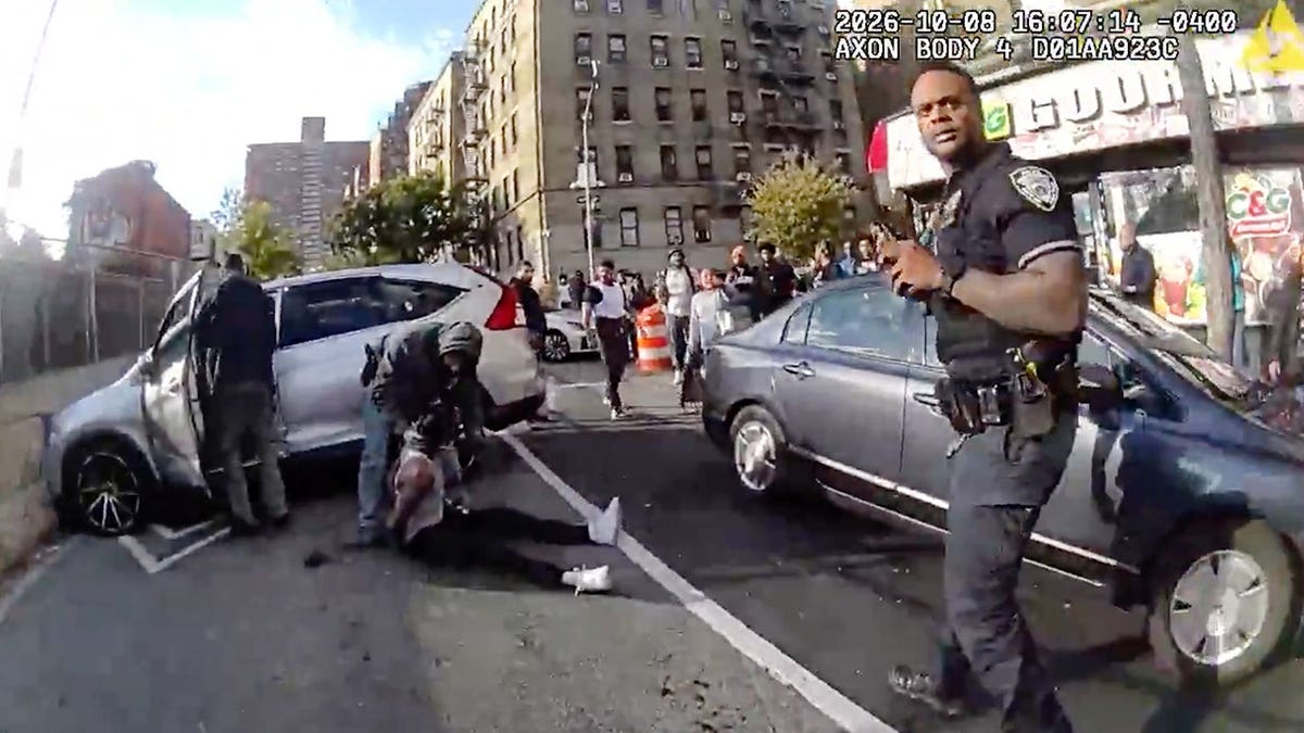 Oscar Belgal lies on the ground as law enforcement personnel tend to him.