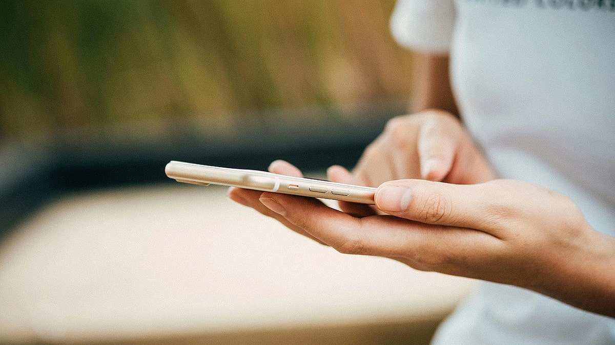 Person typing on cellphone