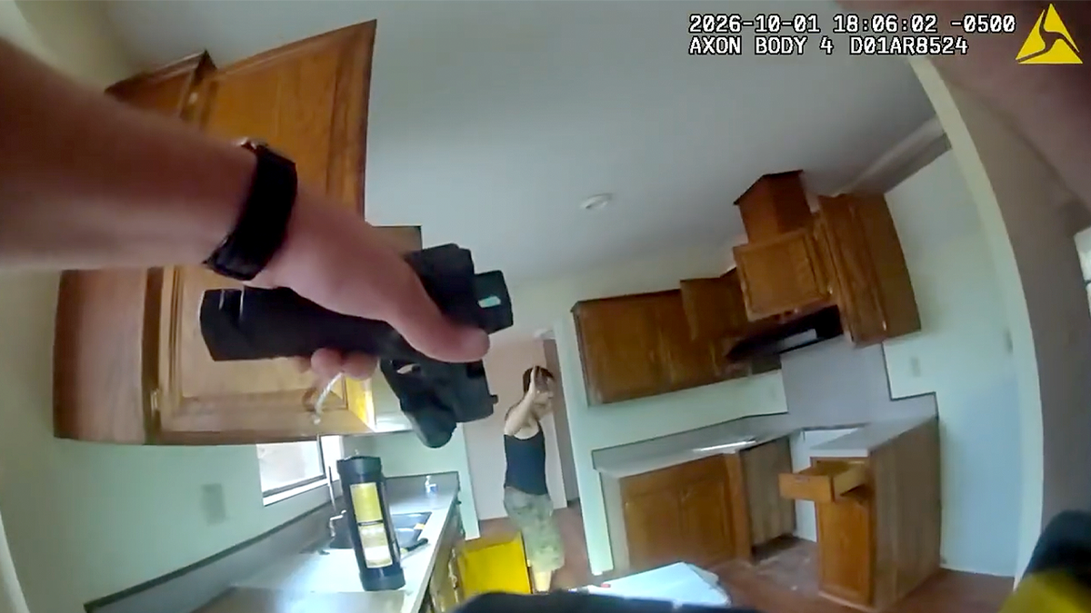 Deputy points a handgun toward Rayven Lee Wooten inside a vacant home’s kitchen