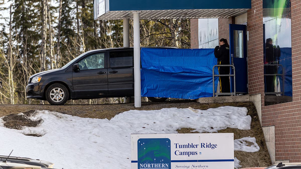 Police officers and investigators work outside the high school building where a mass shooting took place in the small town of Tumbler Ridge, British Columbia, on February 11, 2026. Canadian police said February 11 an 18-year-old carried out a mass shooting in a remote mining town, killing six people at a local school, after slaying her mother and stepbrother. Police commander Dwayne McDonald said authorities still don't know the motive in Tuesday's mass shooting in Tumbler Ridge, but the shooter, who took her own life, was known to have mental health issues. (Photo by Eagle Vision Agency / AFP via Getty Images)
